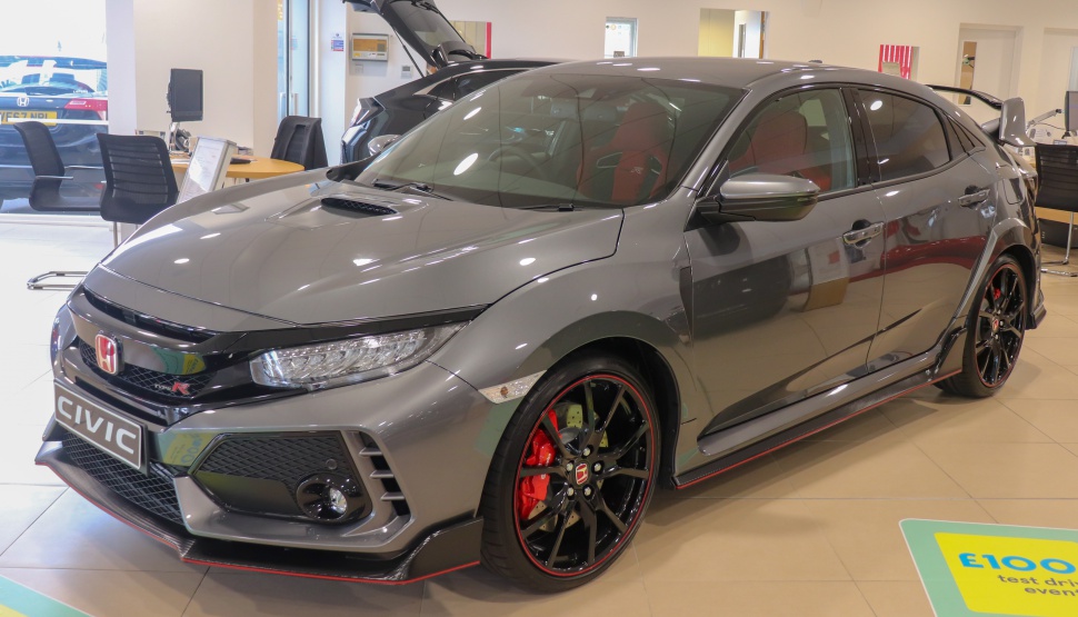 Gray sporty hatchback with black wheels and red brake calipers