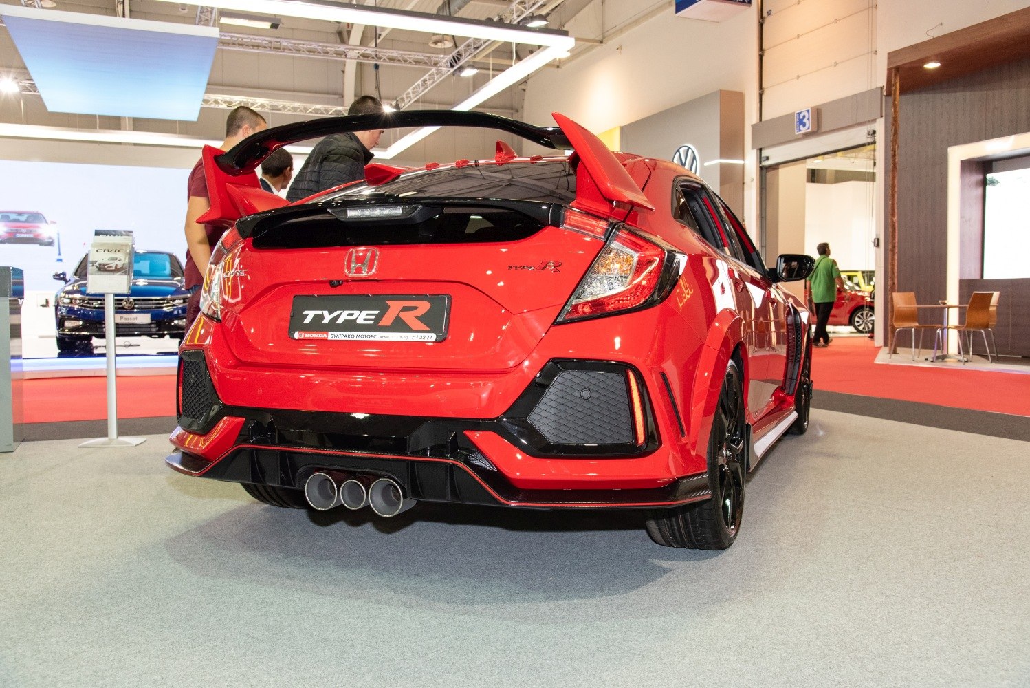 Aggressive rear hatchback with triple exhausts and prominent rear spoiler