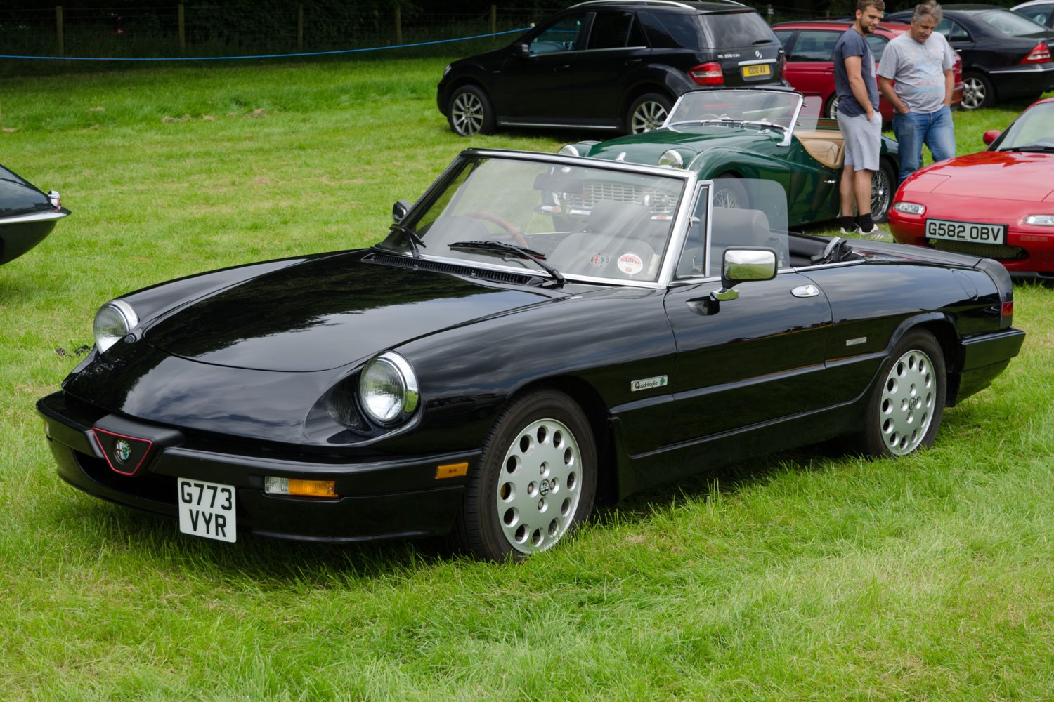 Black convertible roadster with pop-up headlights and alloy wheels