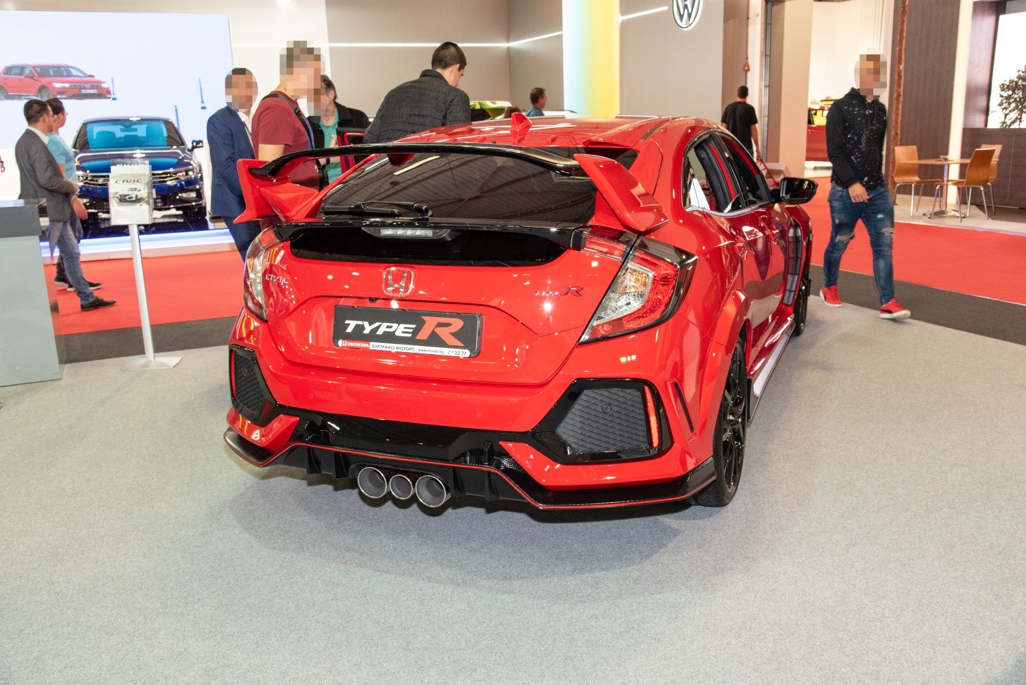 Aggressive rear wing, triple central exhaust, and detailed rear diffuser.