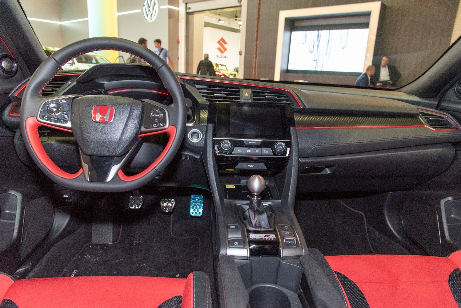 Sporty red-accented steering wheel and center console with manual gear shifter
