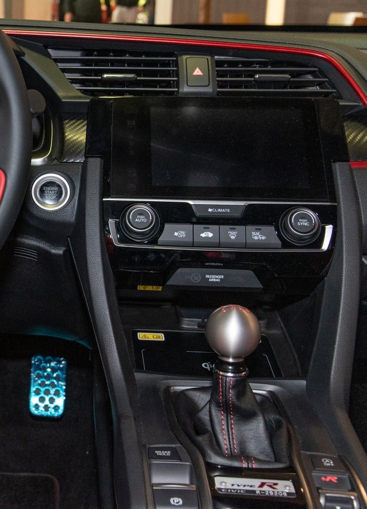 Manual gear shift knob and digital climate control panel in sporty hatchback