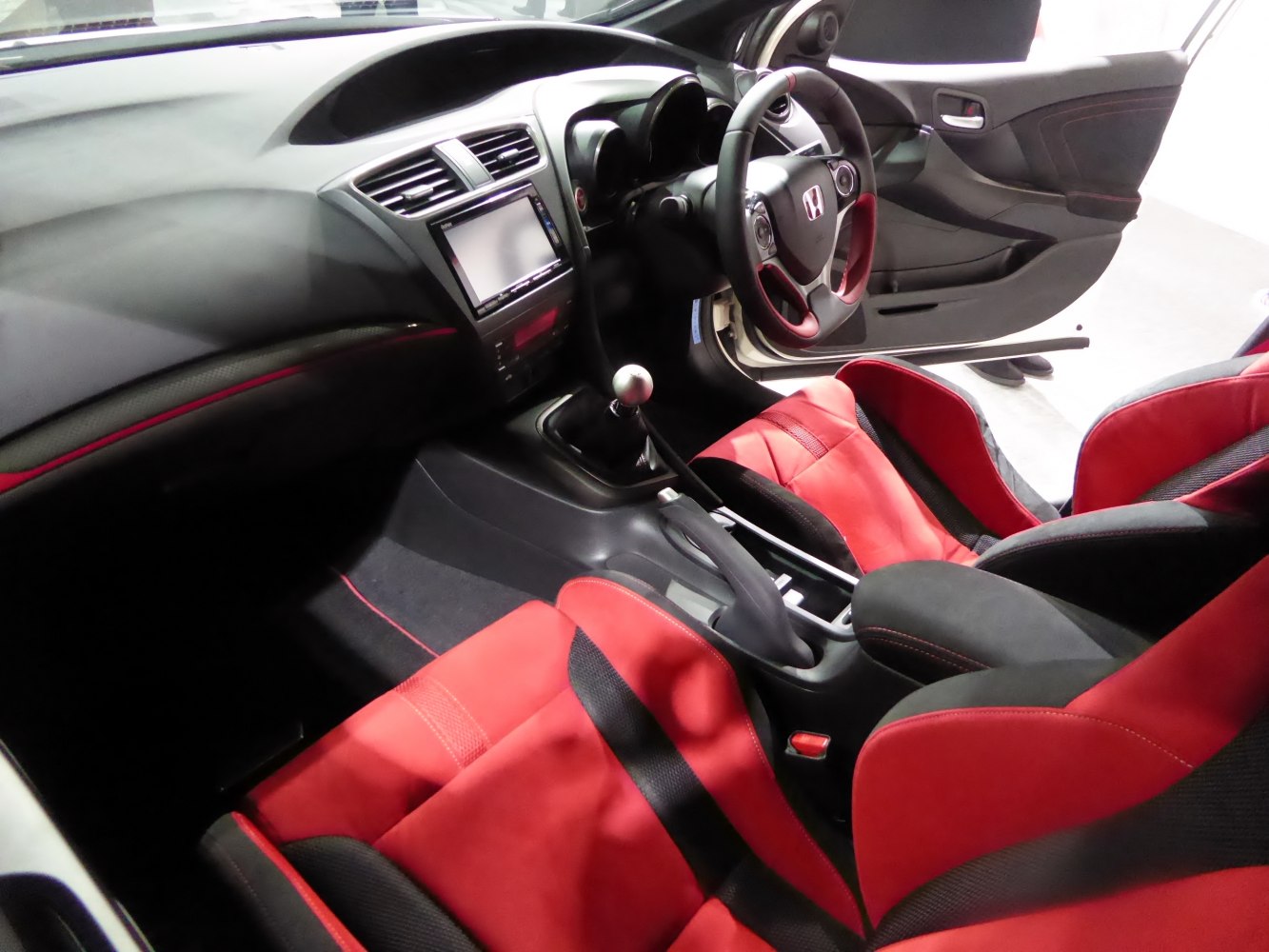 Sporty red bucket seats with manual gearbox and center console