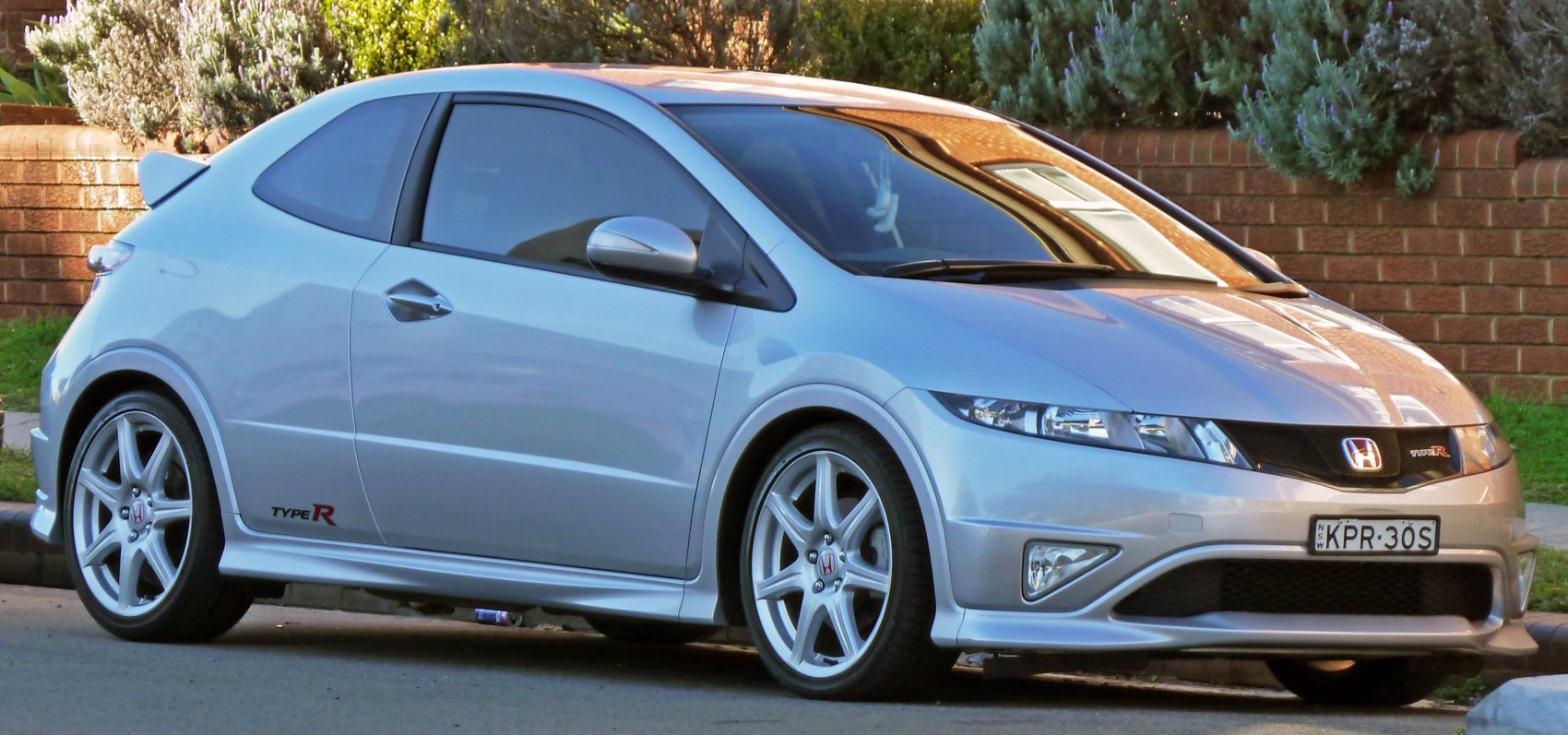 Silver sporty hatchback with front side view and alloy wheels