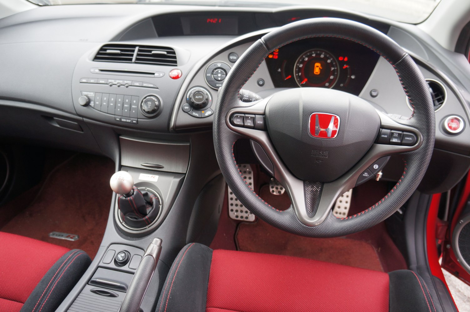 Steering wheel, manual gear shift, red sport seats interior