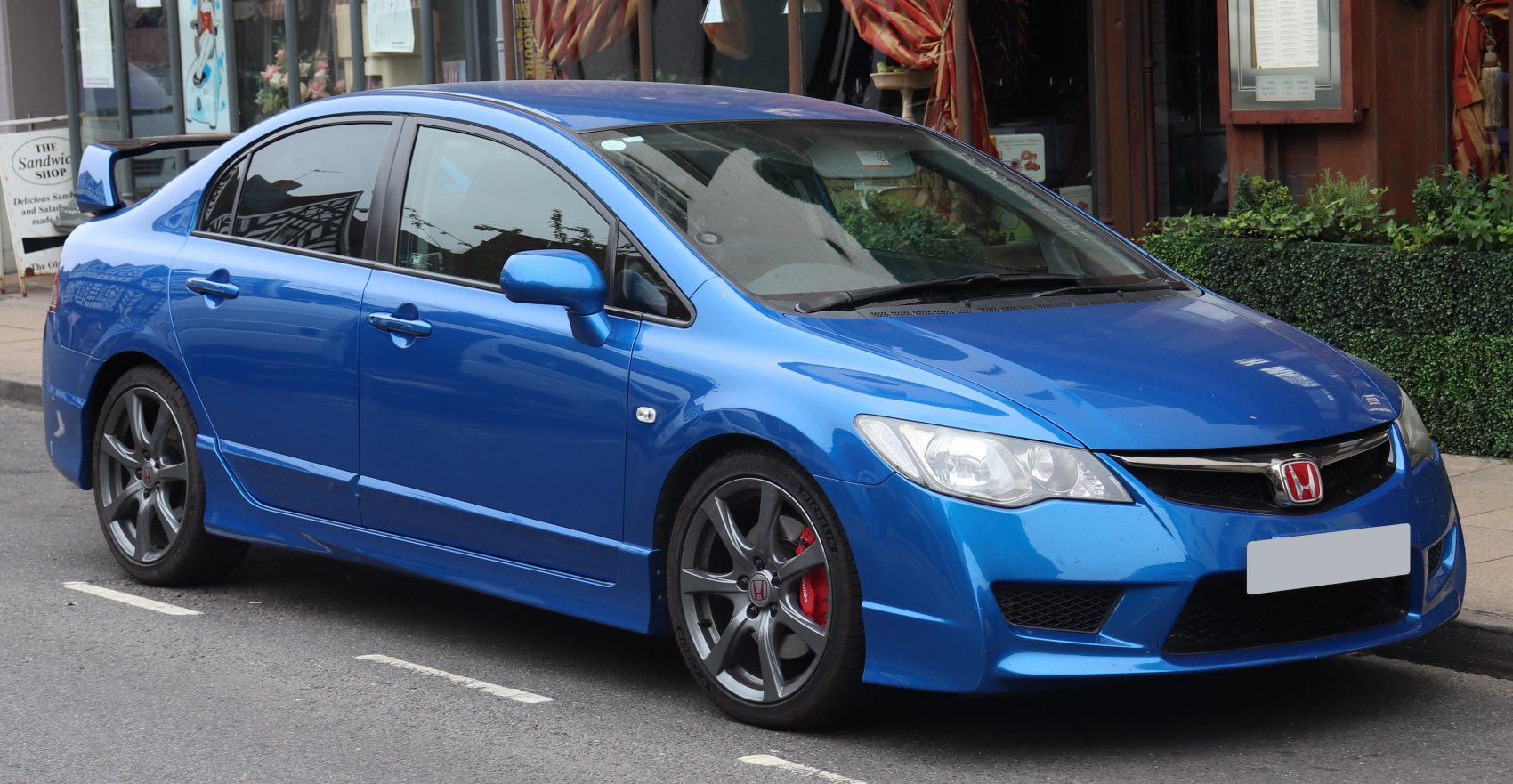 Blue sporty sedan with aggressive front and rear spoiler