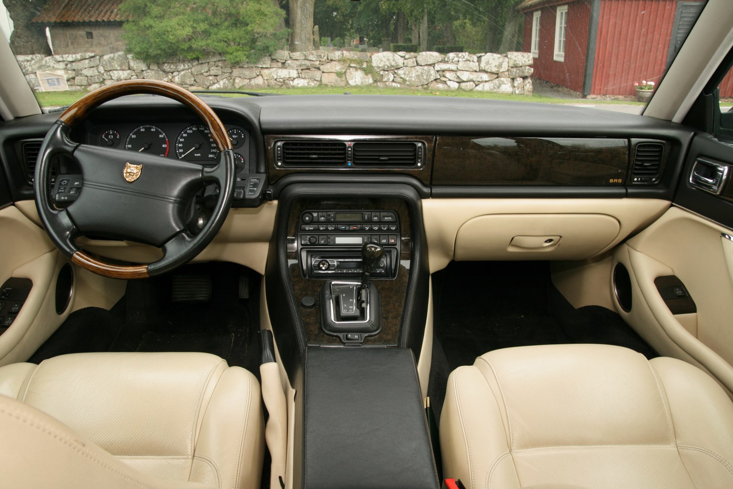 Leather seats and wood-trimmed steering wheel with classic dashboard controls