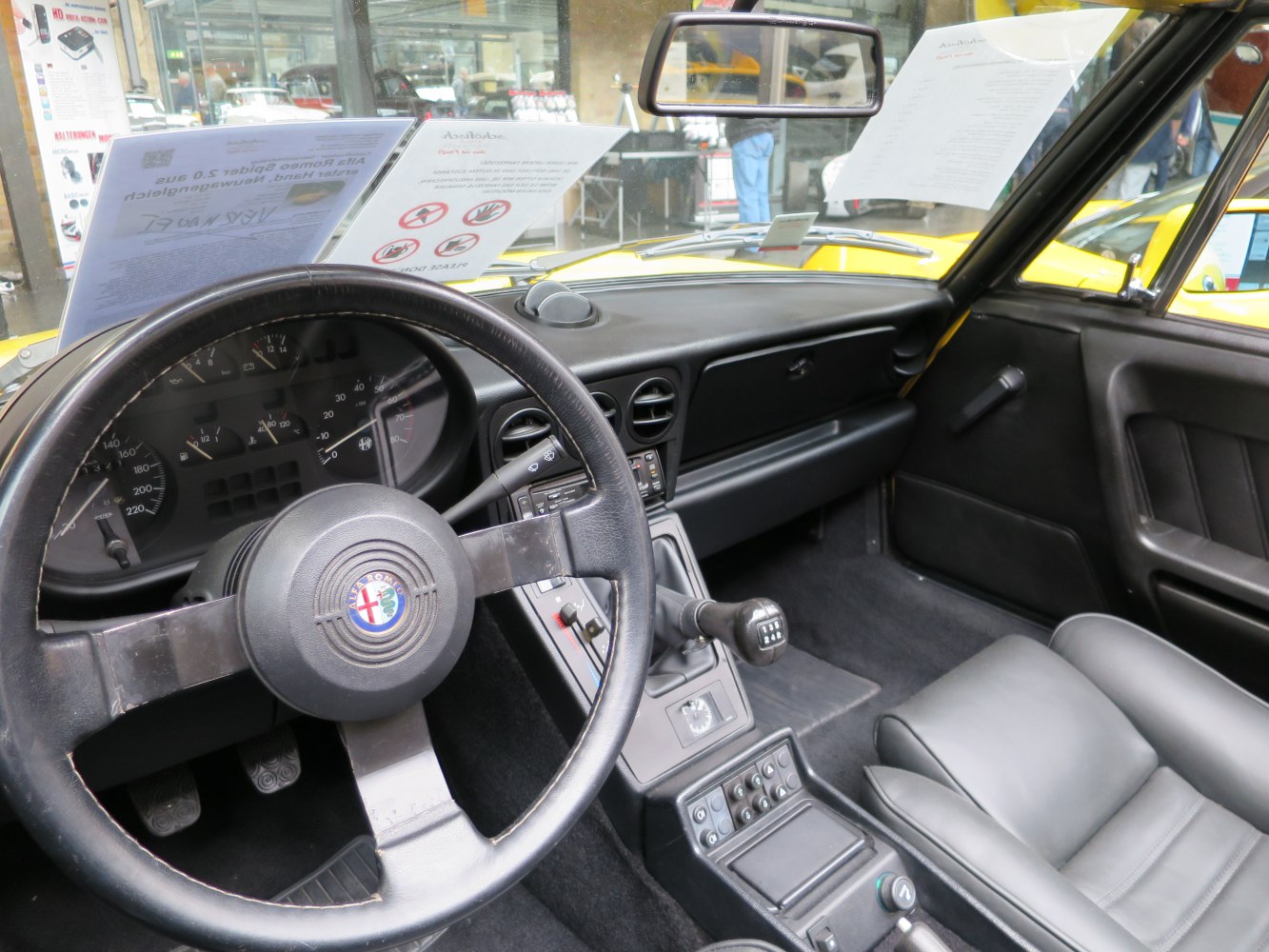 Vintage sports car interior with steering wheel and manual transmission gearshift