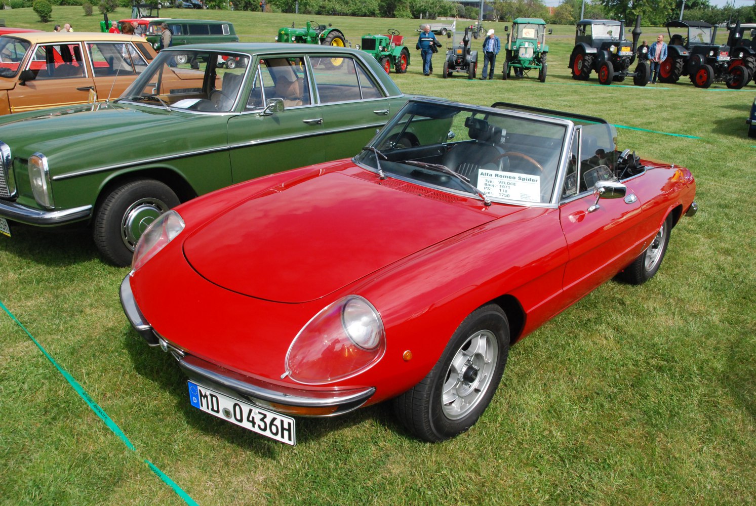 Red convertible with rounded headlights and sleek curves