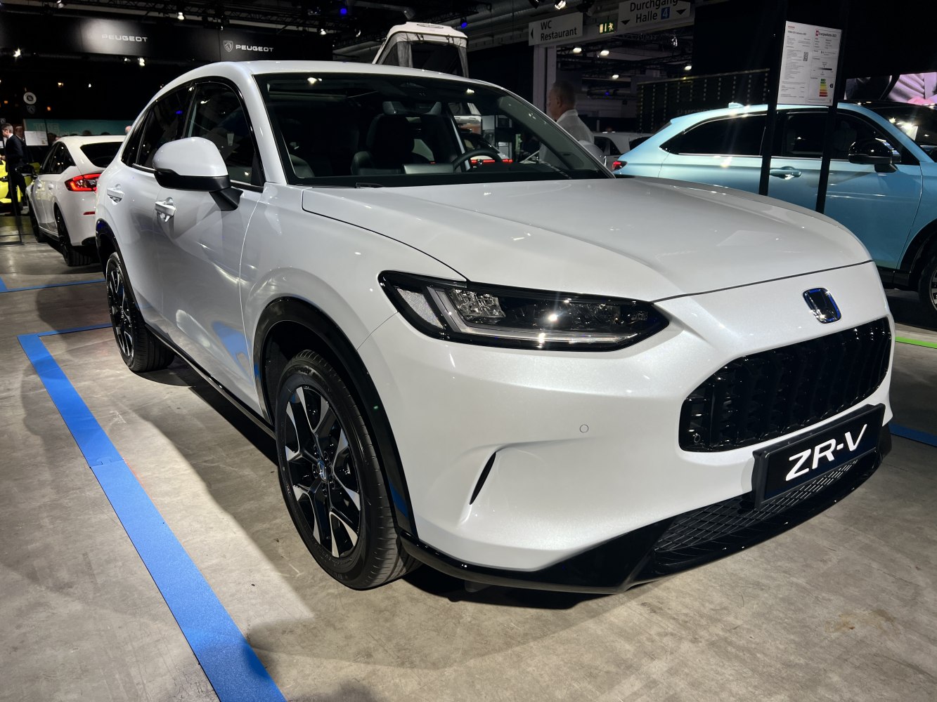 Front view of white SUV with black alloy wheels and sleek headlights