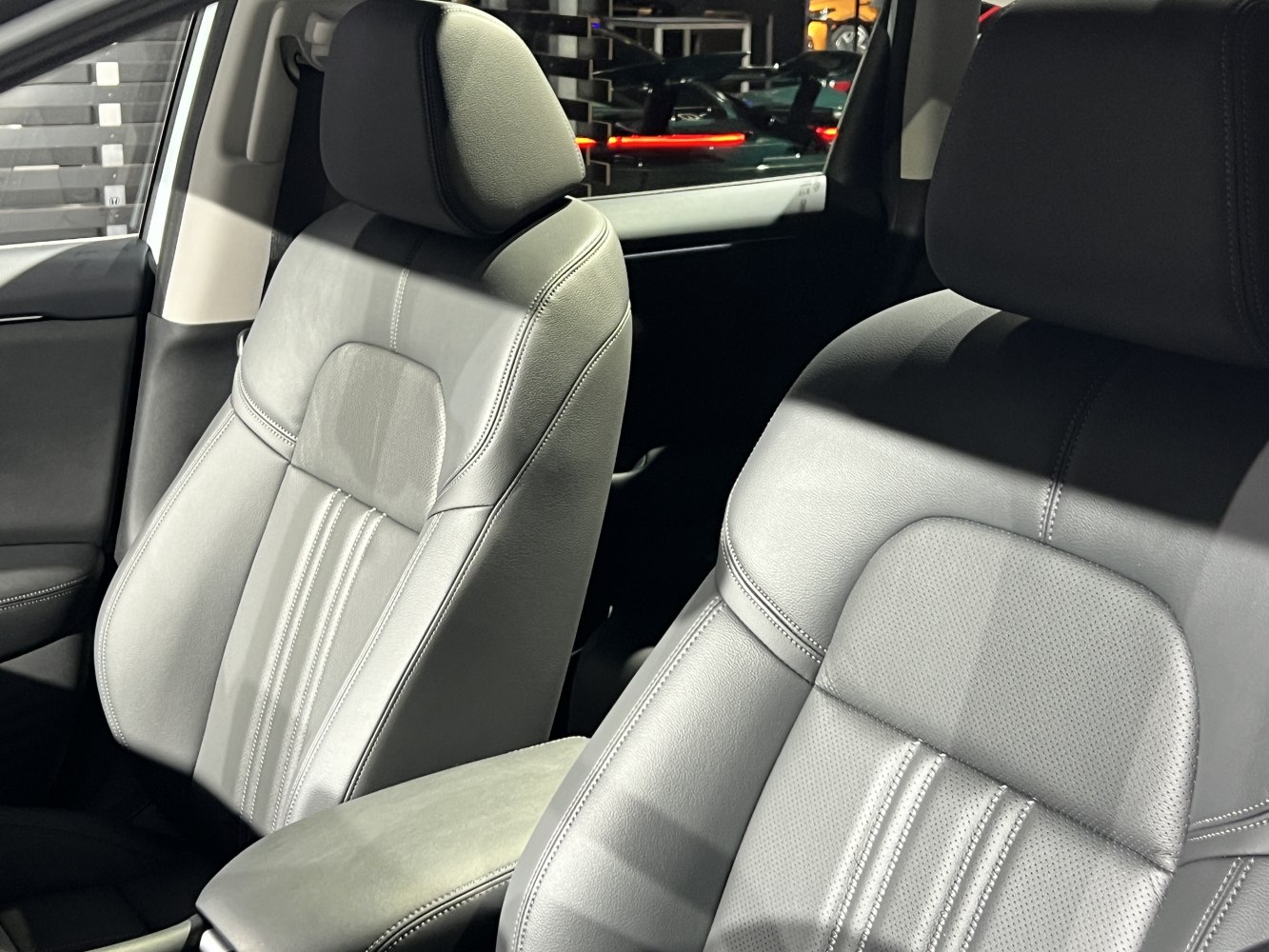 Leather front seats with detailed stitching inside vehicle