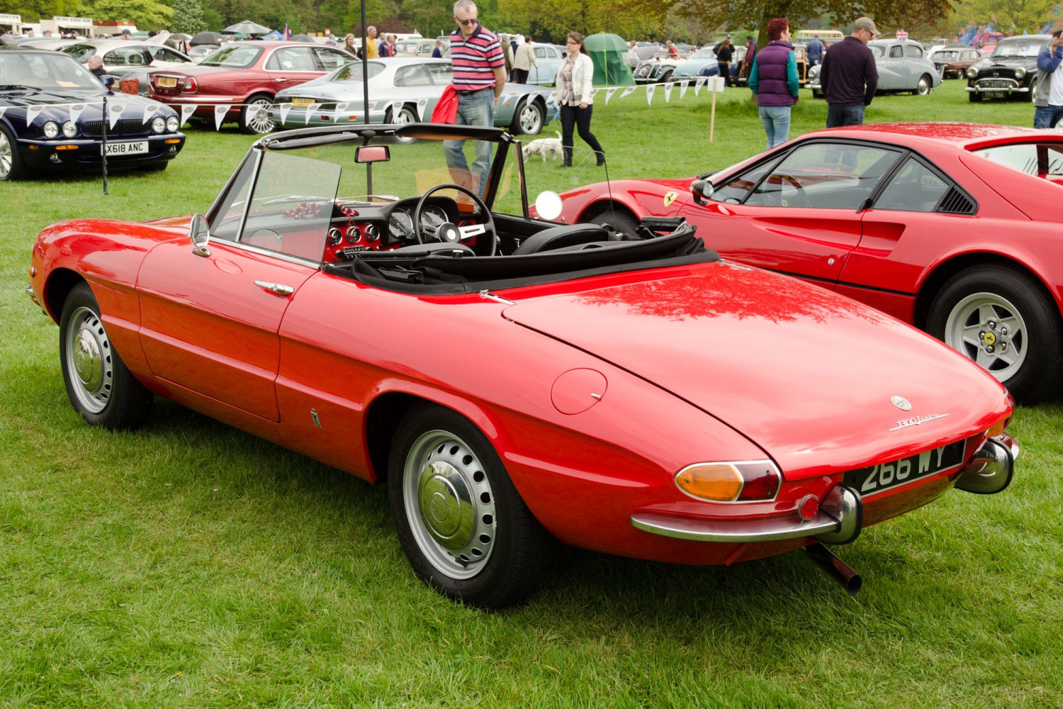 Red classic convertible with open roof and vintage design.