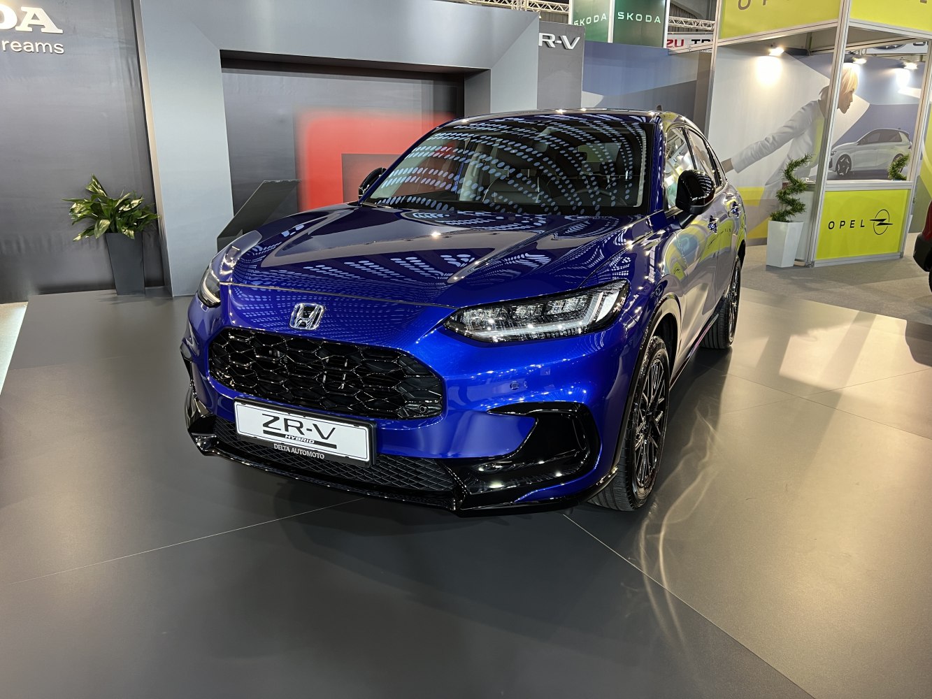 Front grille and LED headlights of blue hybrid SUV