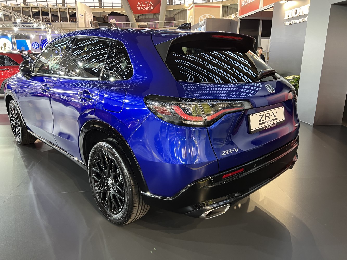 Rear side of a blue hybrid SUV with LED taillights and black alloy wheels