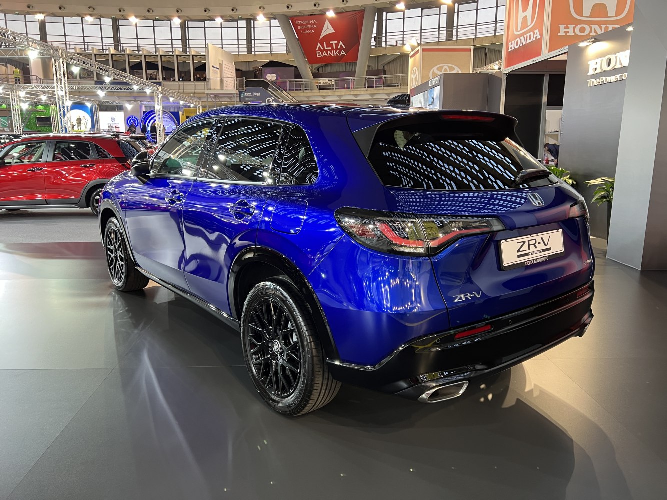 Rear view of a blue SUV with LED tail lights and black alloy wheels
