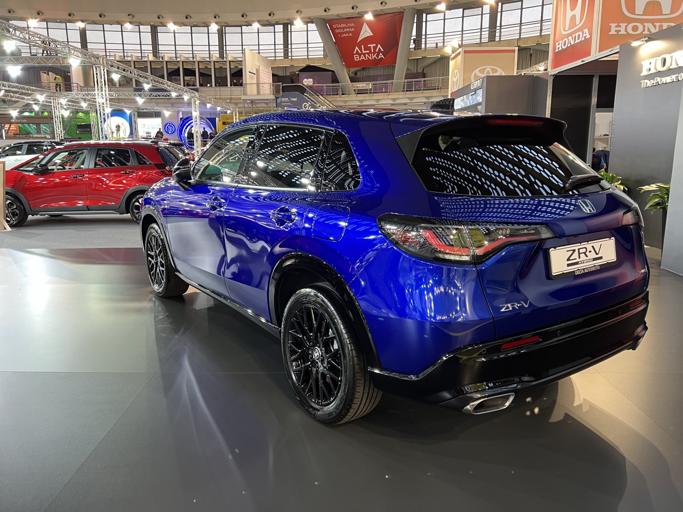 Rear and side view of a blue SUV with black alloy wheels and LED taillights