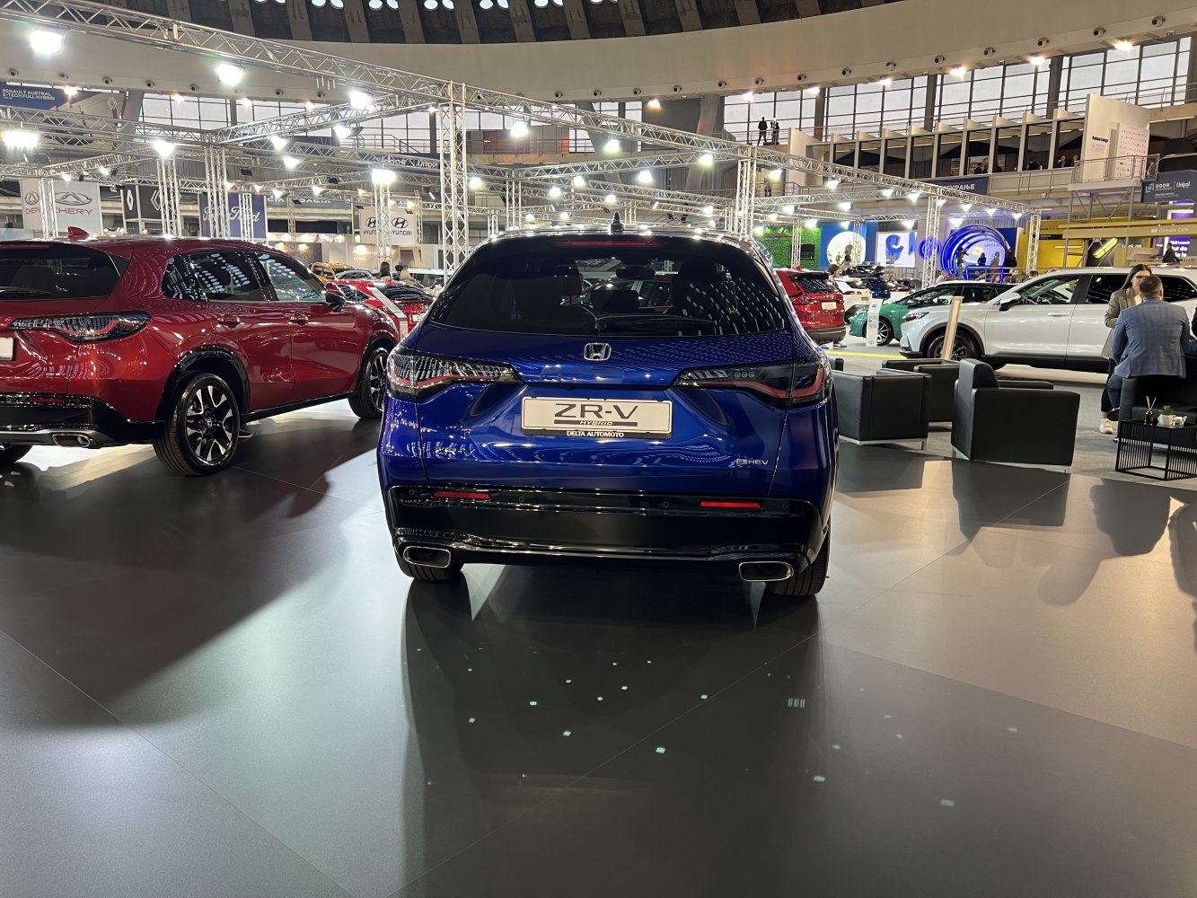 Rear view of a blue hybrid SUV with distinct LED taillights and dual exhausts.