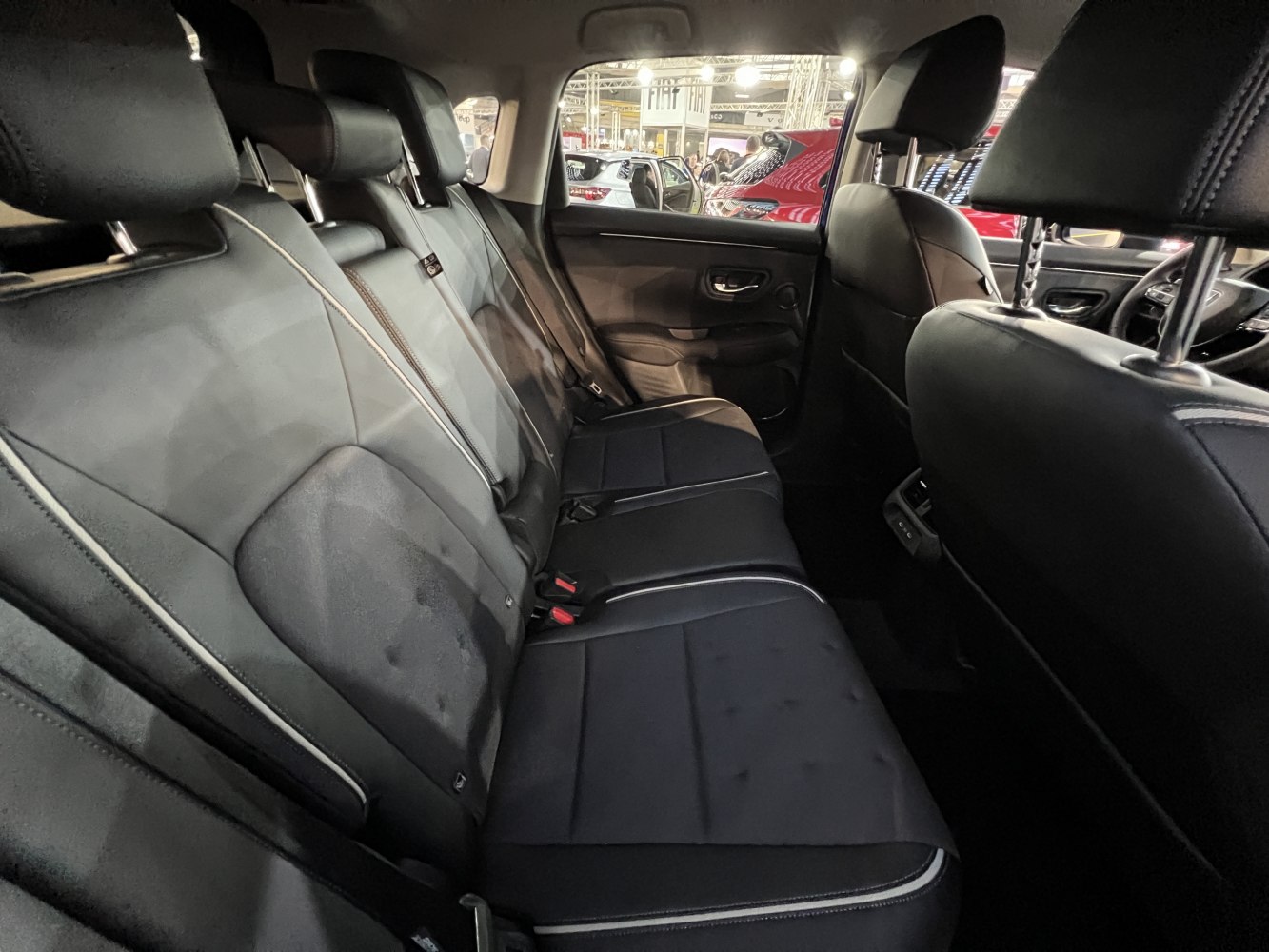 Spacious rear leather seats with headrests and seat belts