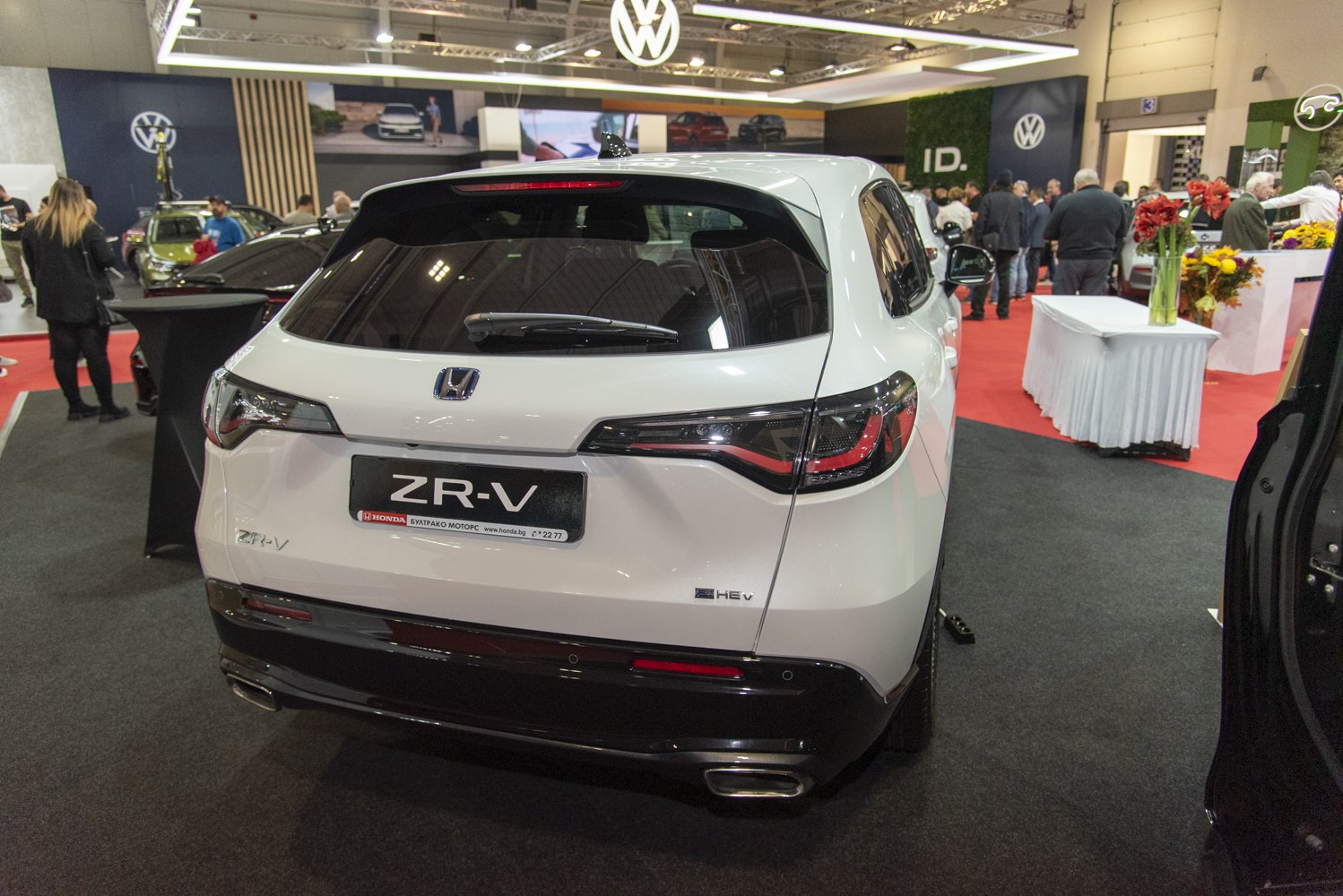 Rear view with hybrid badge, sleek taillights, dual exhaust tips