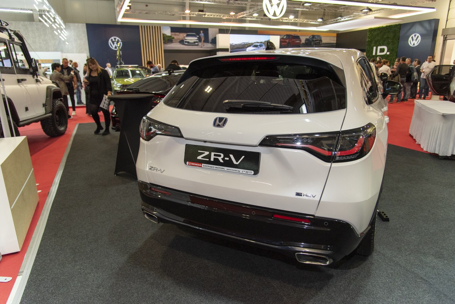 Rear view with tail lights, hybrid badge, and dual exhaust outlets