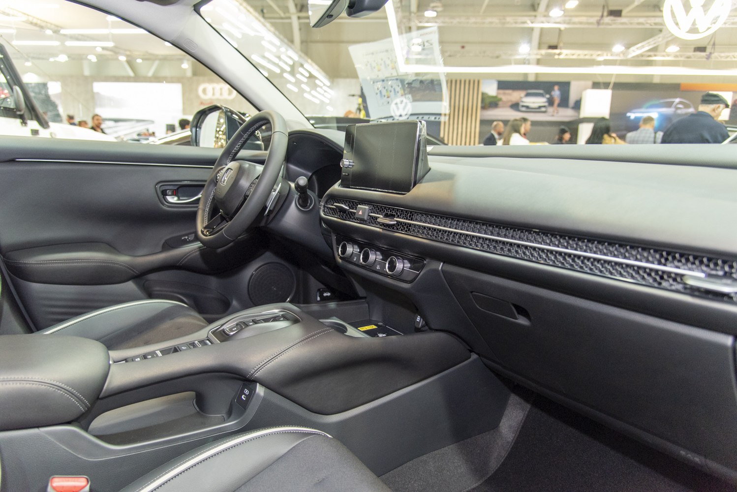 Modern car interior with dashboard, touchscreen, and steering wheel