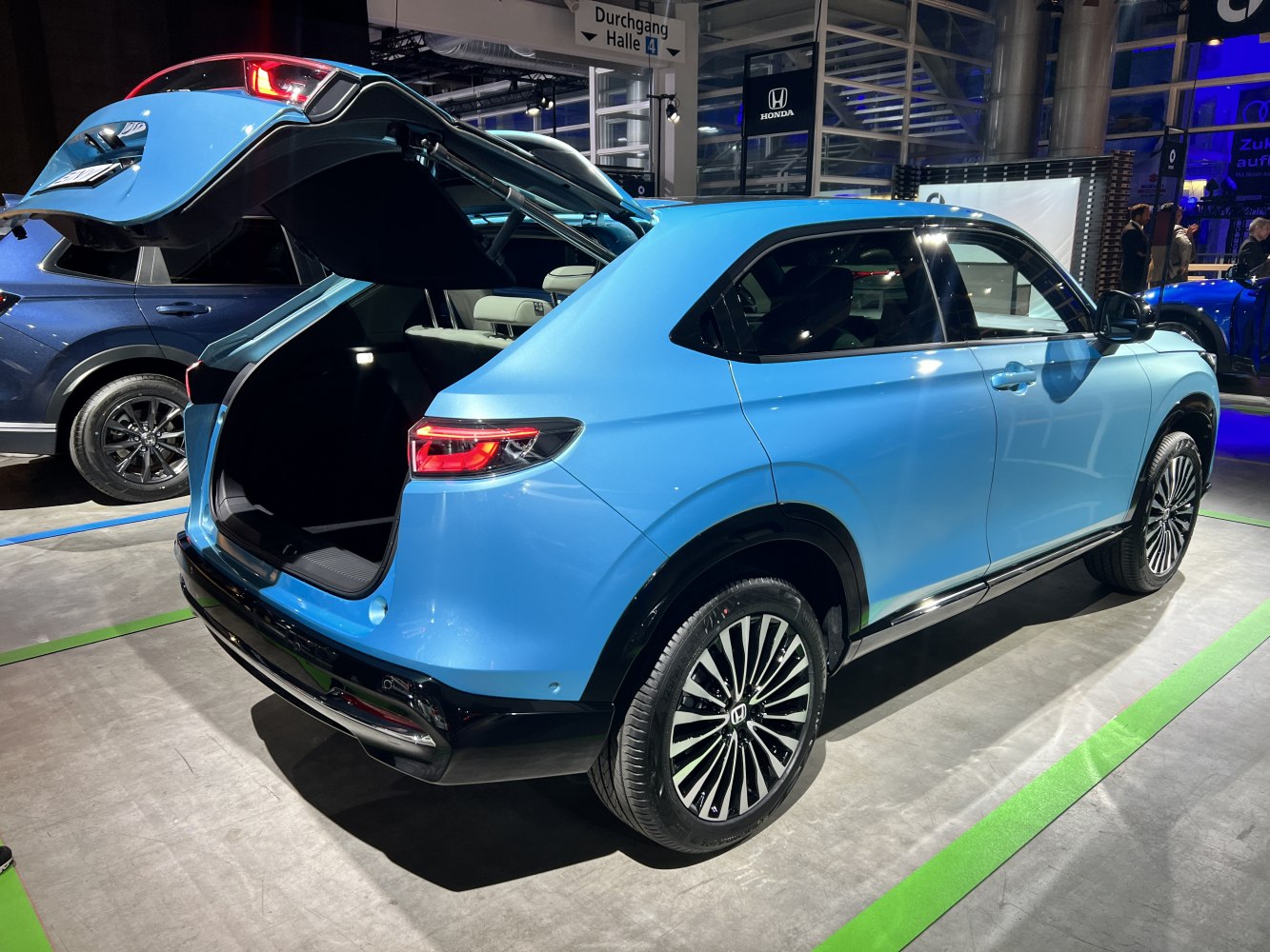 Electric SUV with open rear hatch and modern alloy wheels