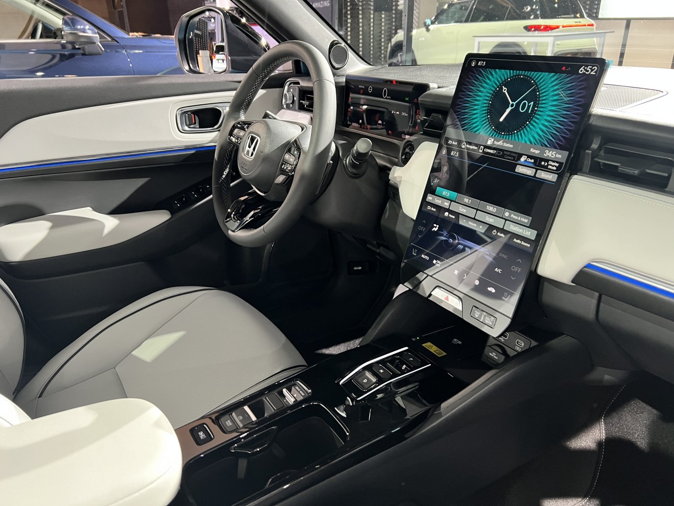 Modern car interior with large vertical touchscreen and digital dashboard