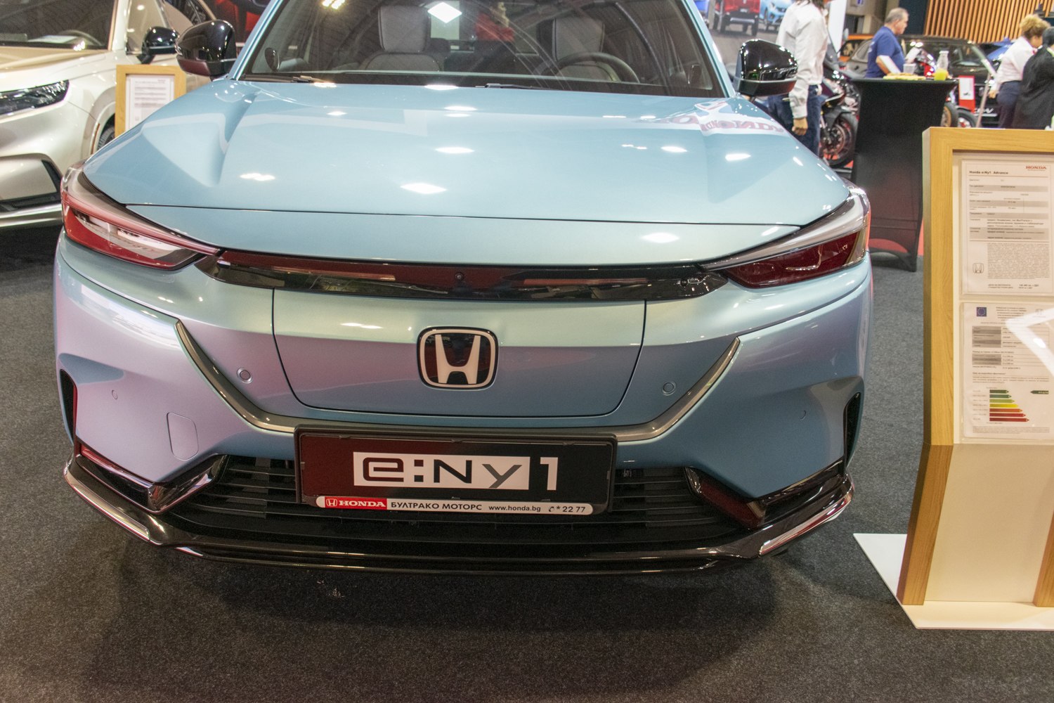 Electric compact car front with LED headlights and grille-less design