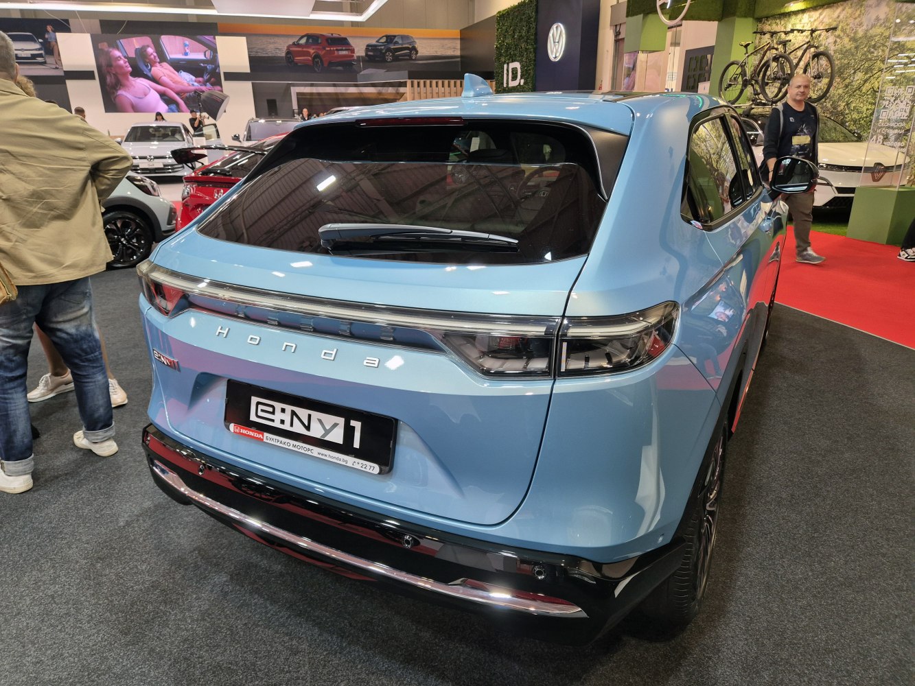 Rear view of a compact electric SUV with integrated taillights and rear wiper