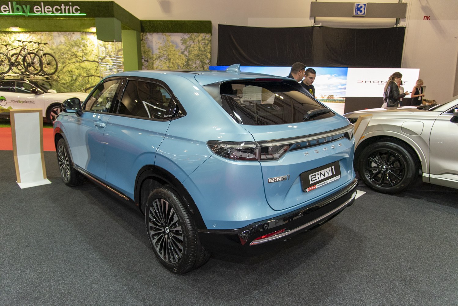 Rear and side view of a modern electric SUV with sleek taillights and aerodynamic styling.