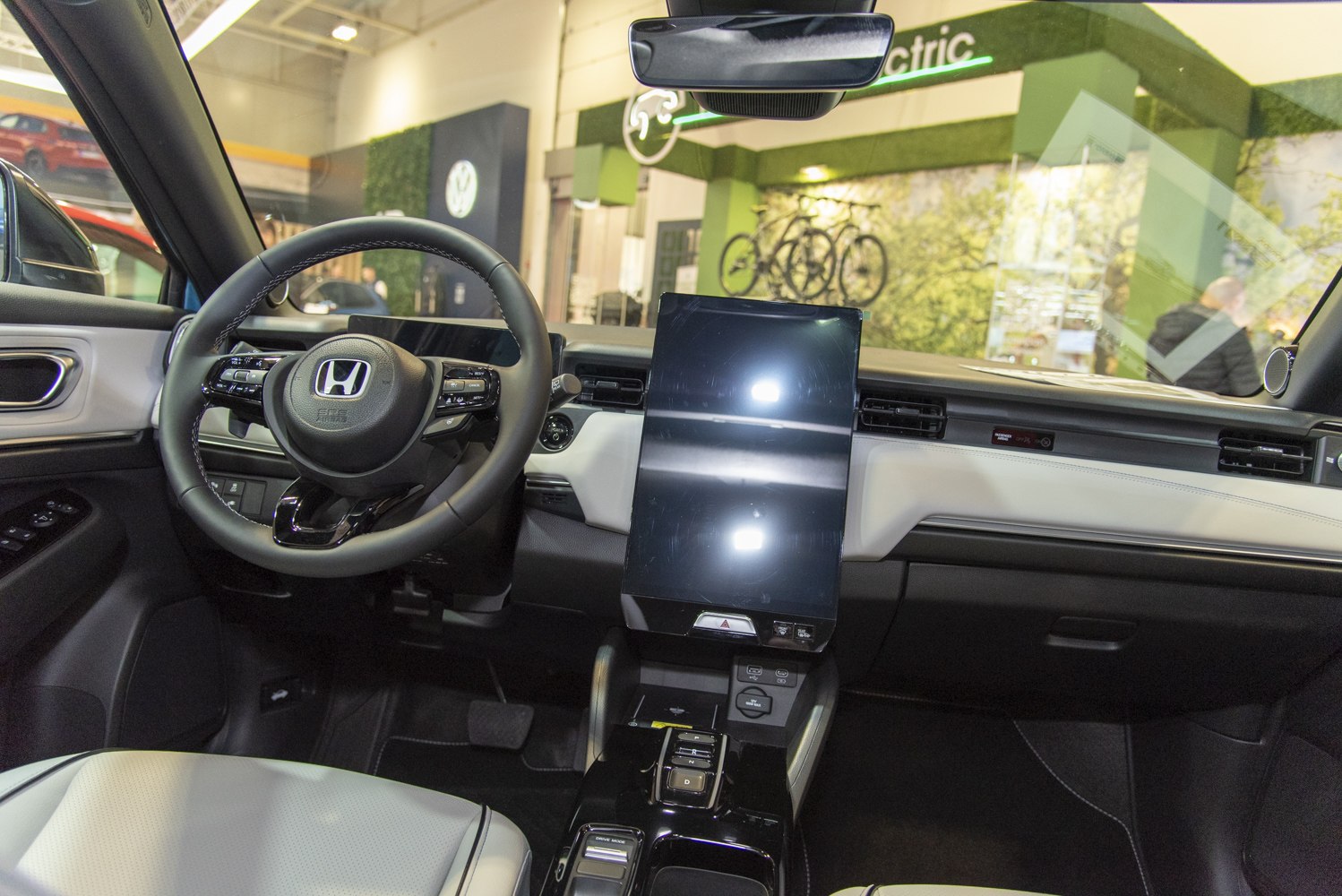 Electric car interior with vertical touchscreen and modern steering wheel