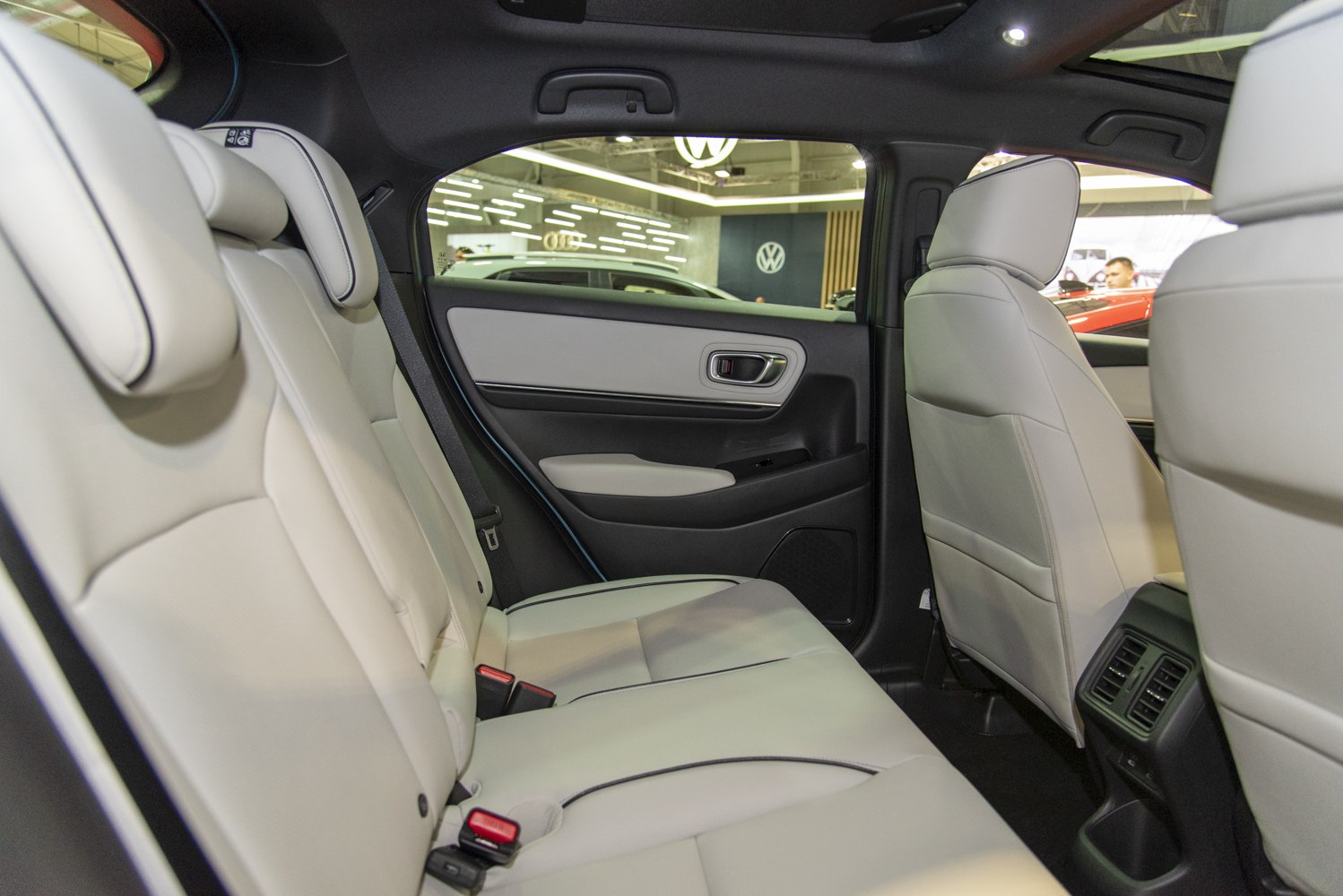 Rear seat with light-colored upholstery and rear air vents