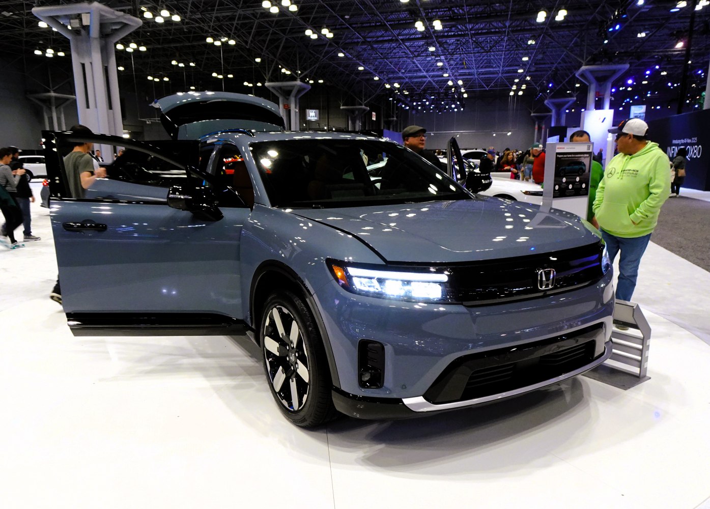 Electric SUV with LED headlights and aerodynamic alloy wheels at auto show