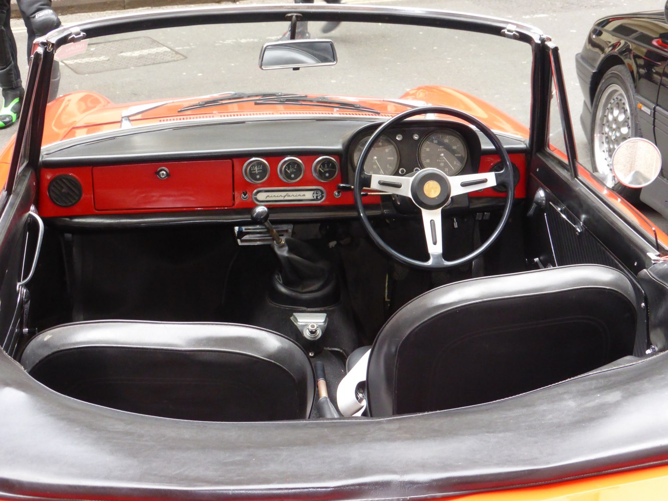 Vintage convertible interior with steering wheel and dashboard gauges