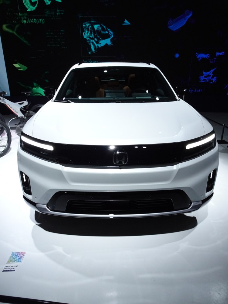 Futuristic front view with sleek LED headlights and modern electric SUV design.