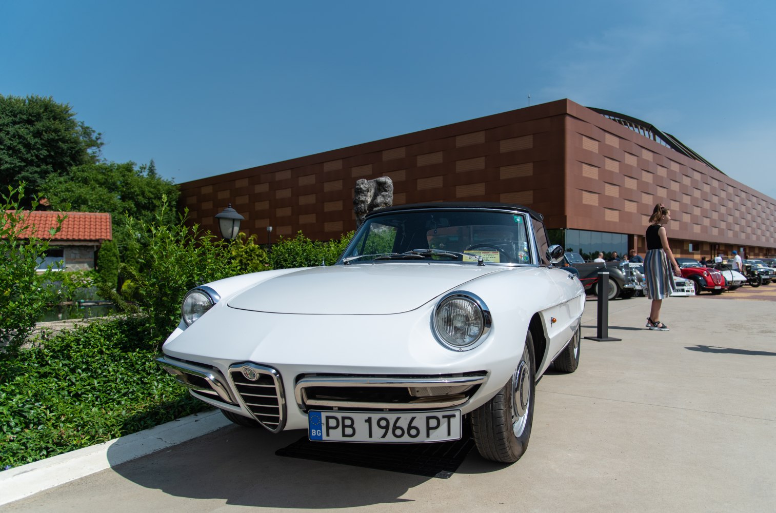 Front view of classic car with round headlights and signature grille