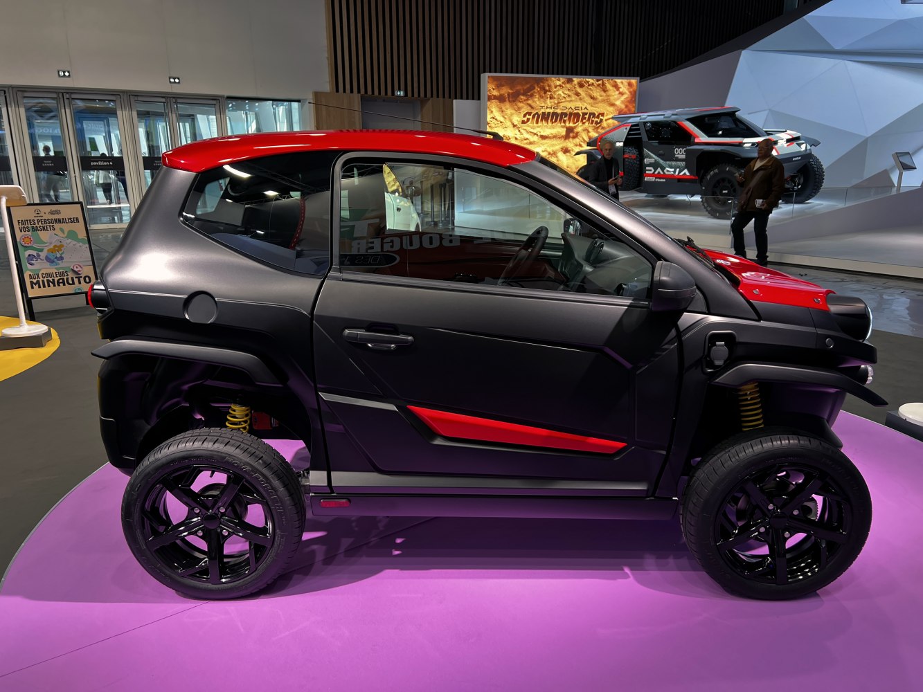 Compact electric vehicle side profile with black-red color scheme