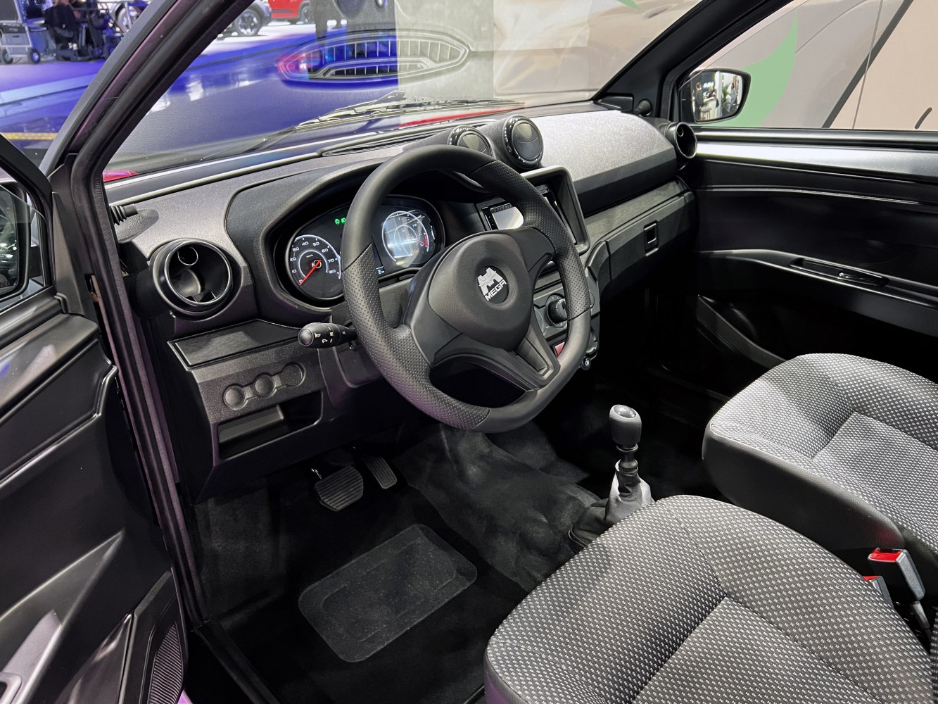 Compact interior with manual gear shift and digital dashboard display