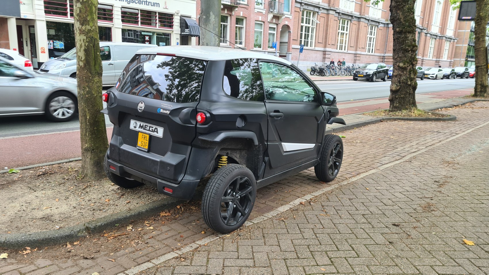 Compact electric microcar with unique rear design and black exterior