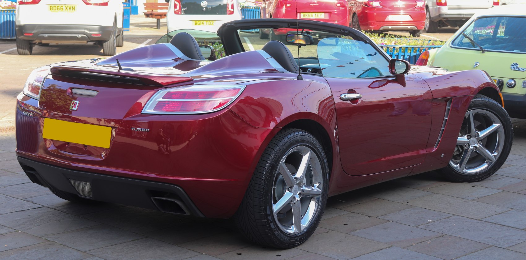 Sleek roadster convertible with twin cockpit and polished alloy wheels
