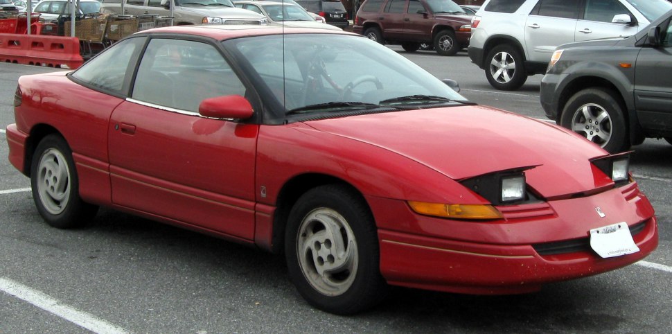 Red coupe with pop-up headlights and classic 90s styling