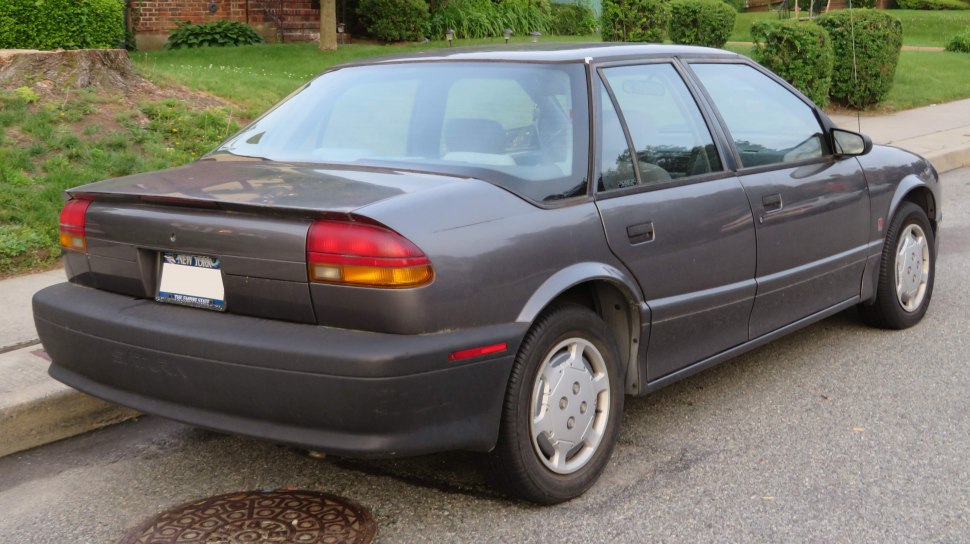 Rear three-quarters view of 1991 sedan with rounded tail lights and black bumper