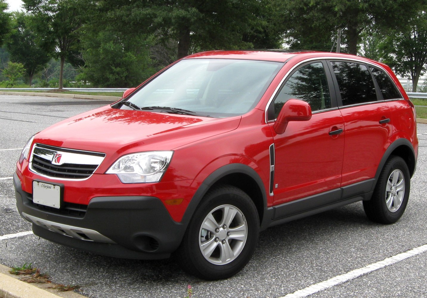 Front side view of red compact SUV with chrome grille and alloy wheels