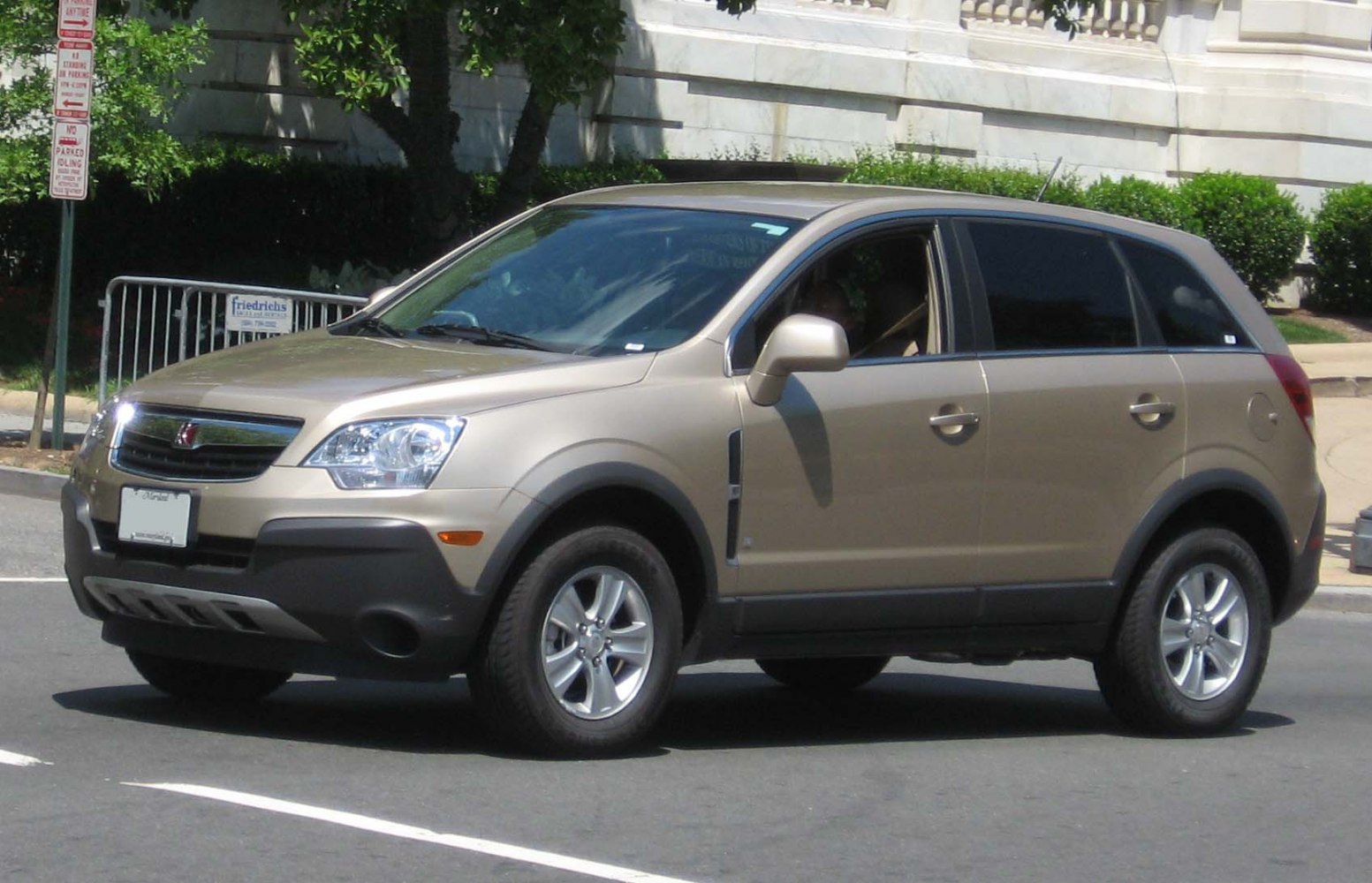 Front side view of compact crossover SUV with urban road background