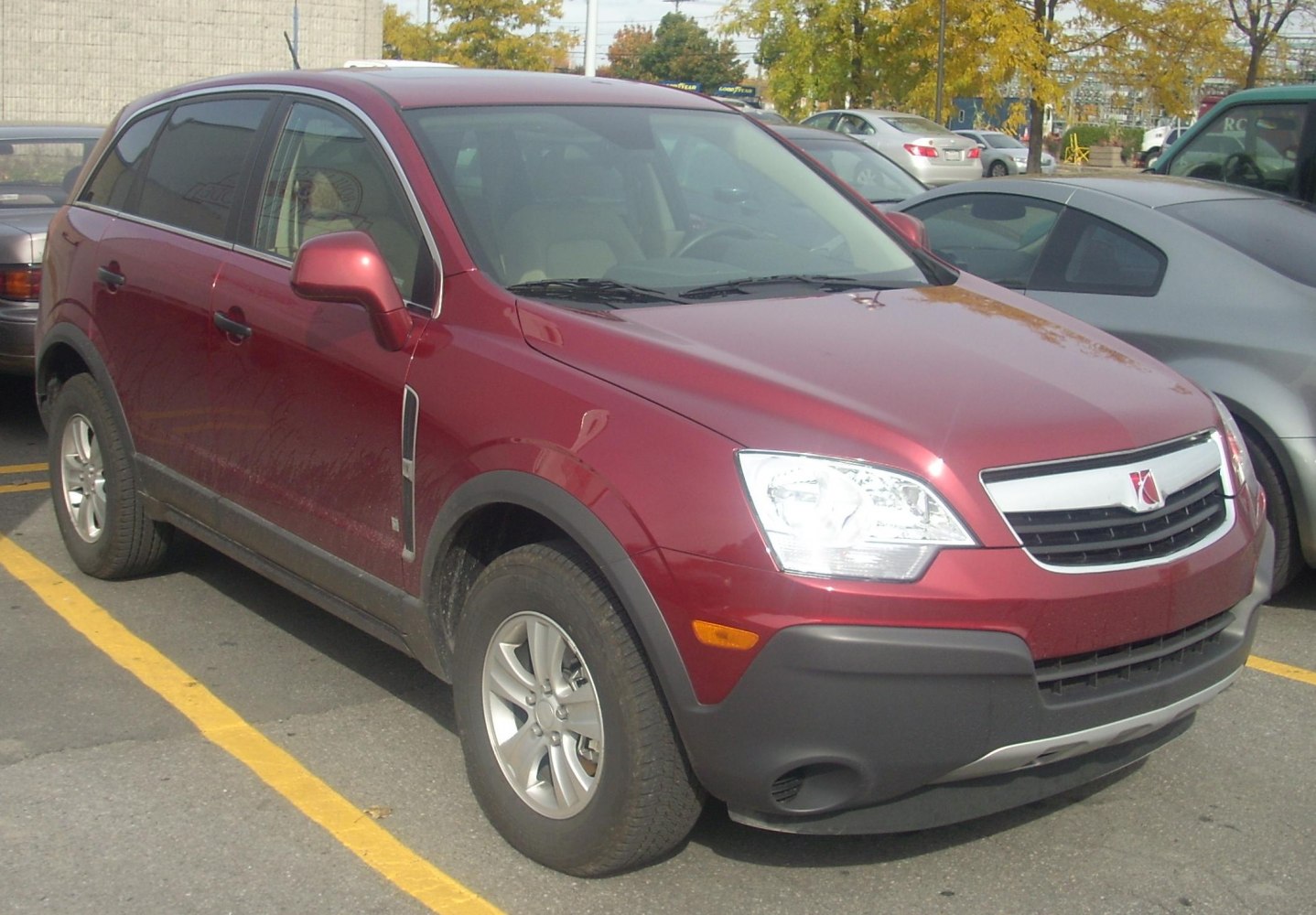 Red compact SUV with bold front grille and alloy wheels