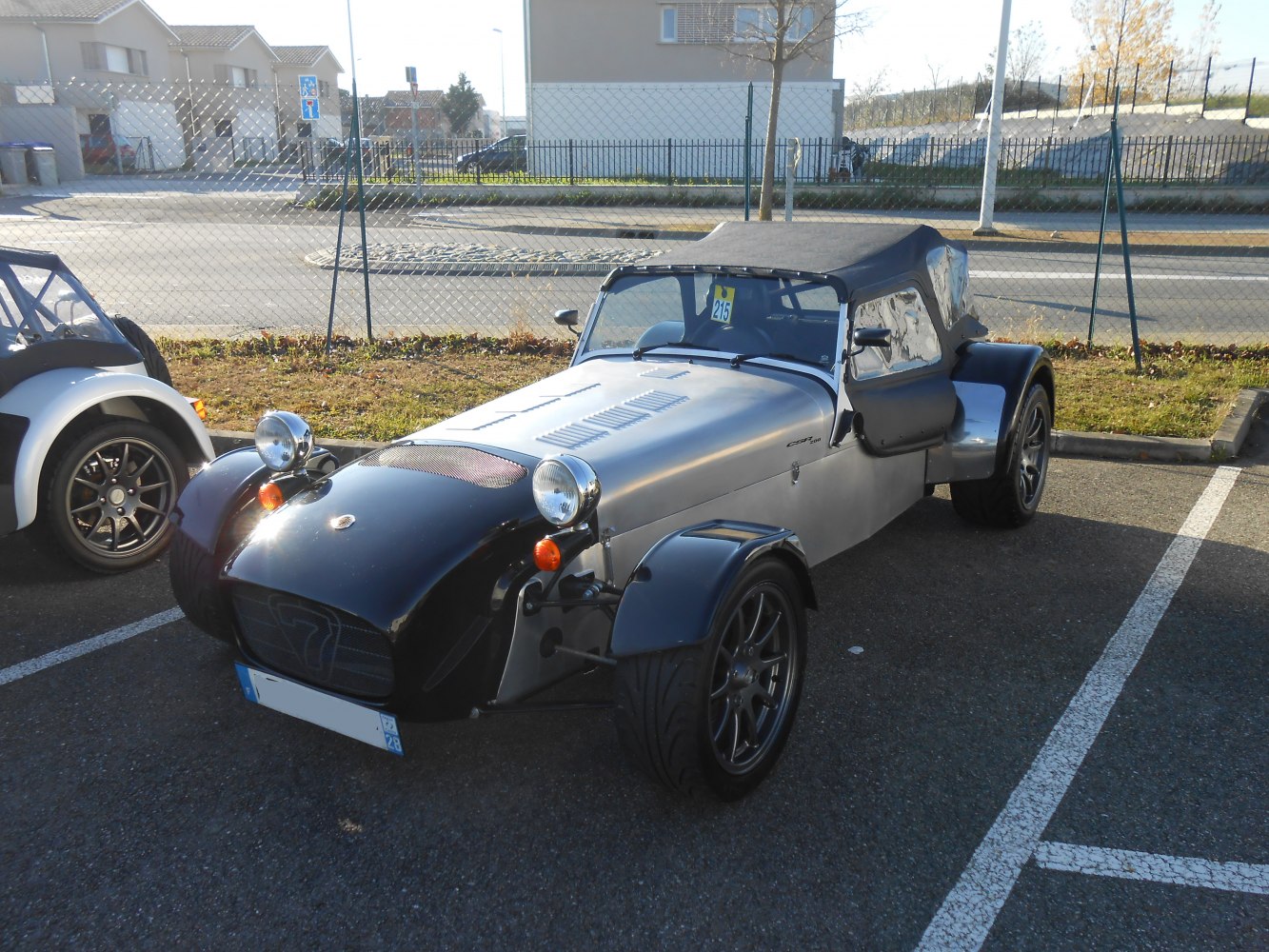Open-top roadster with exposed wheels and round headlights.