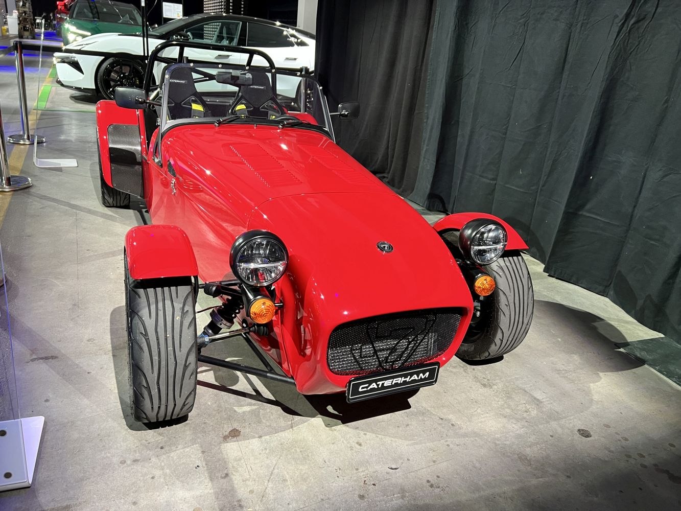 Lightweight open-top sports car with exposed front wheels and red aerodynamic body