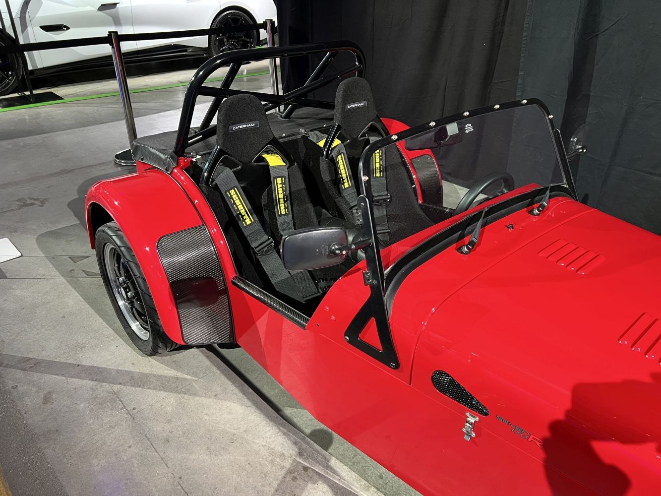 Red open cockpit with roll bar and racing seats