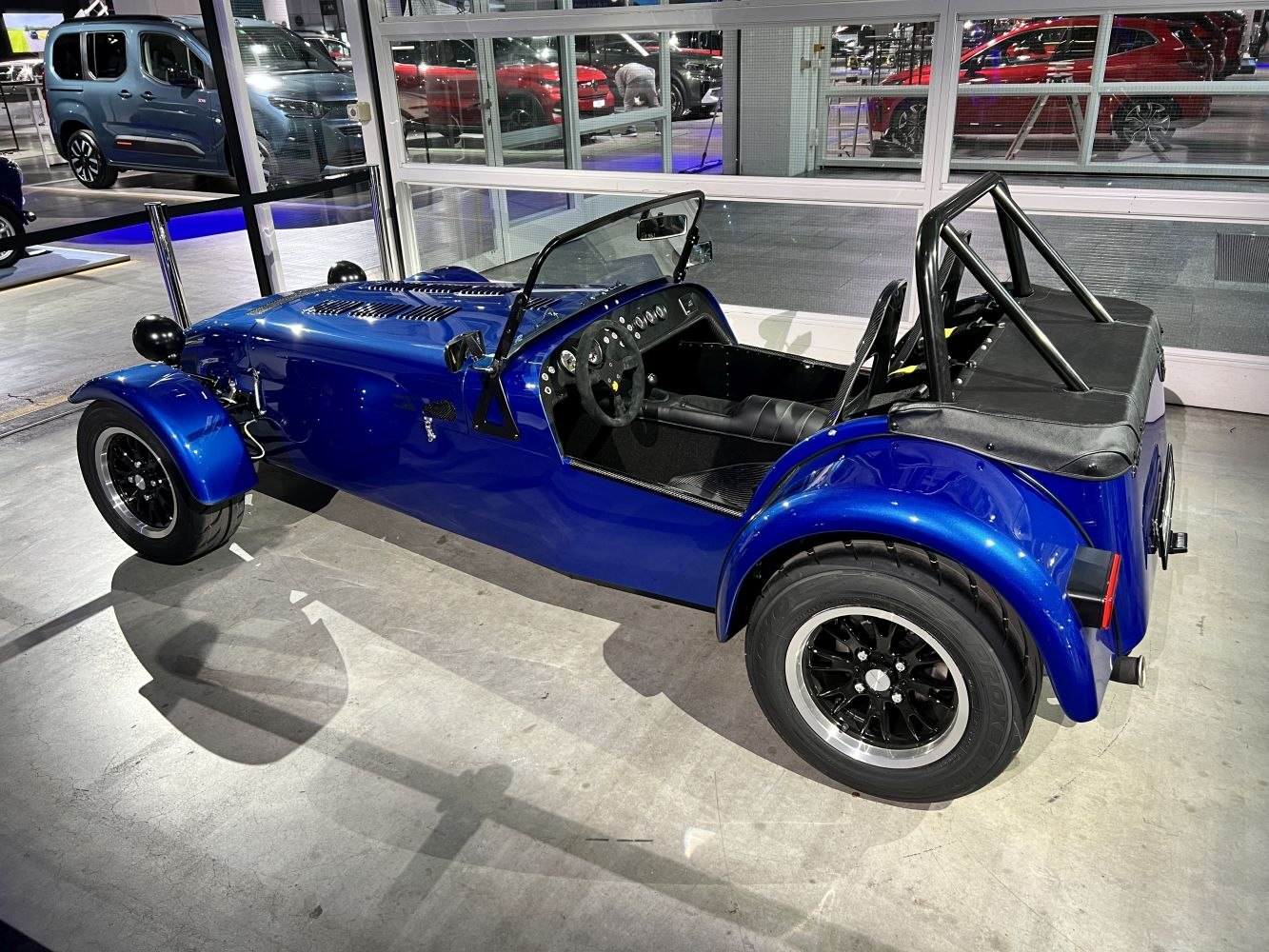 Lightweight roadster with roll cage and minimalist open cockpit interior