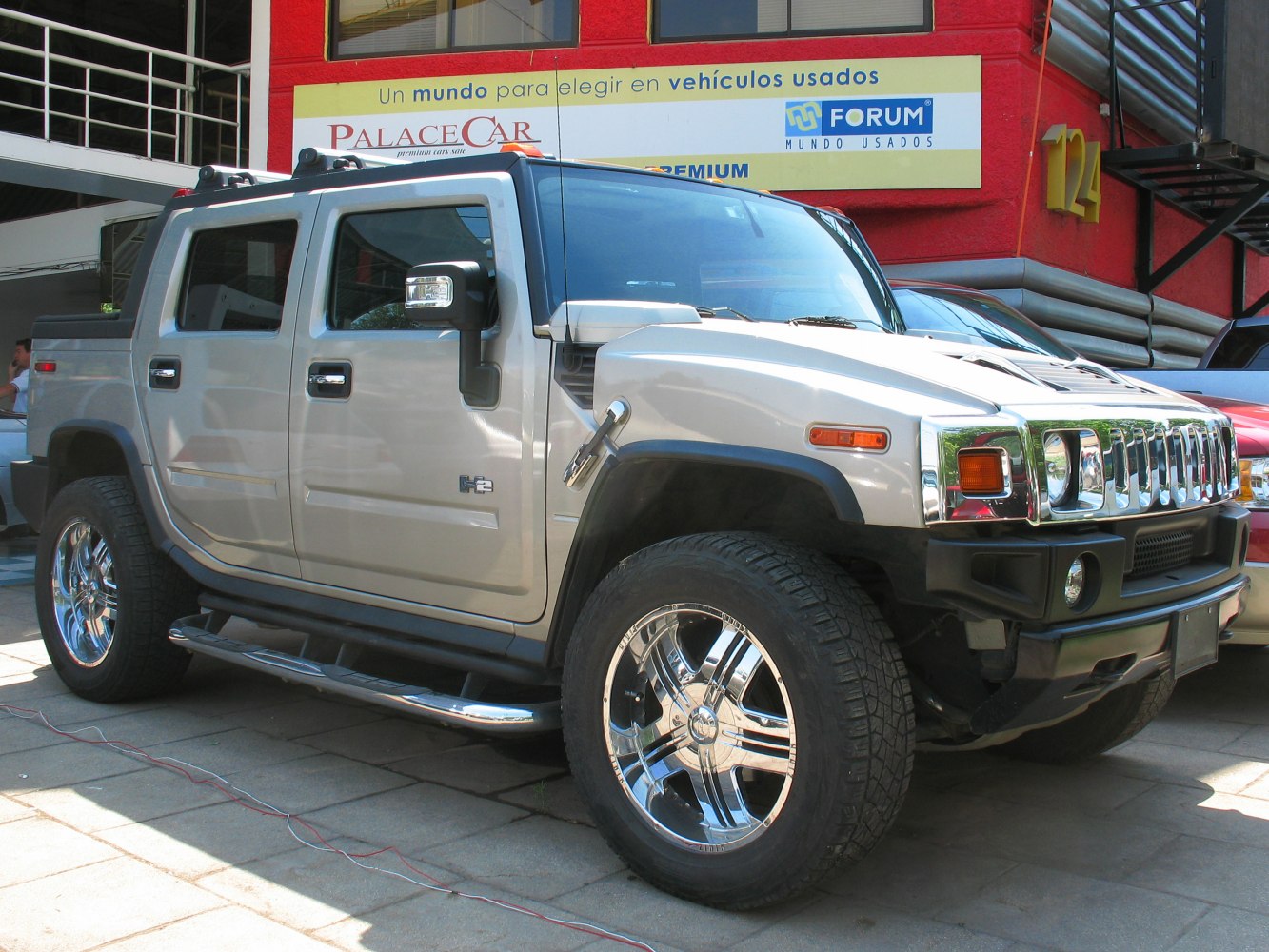 Silver large SUV with bold grille and chrome wheels